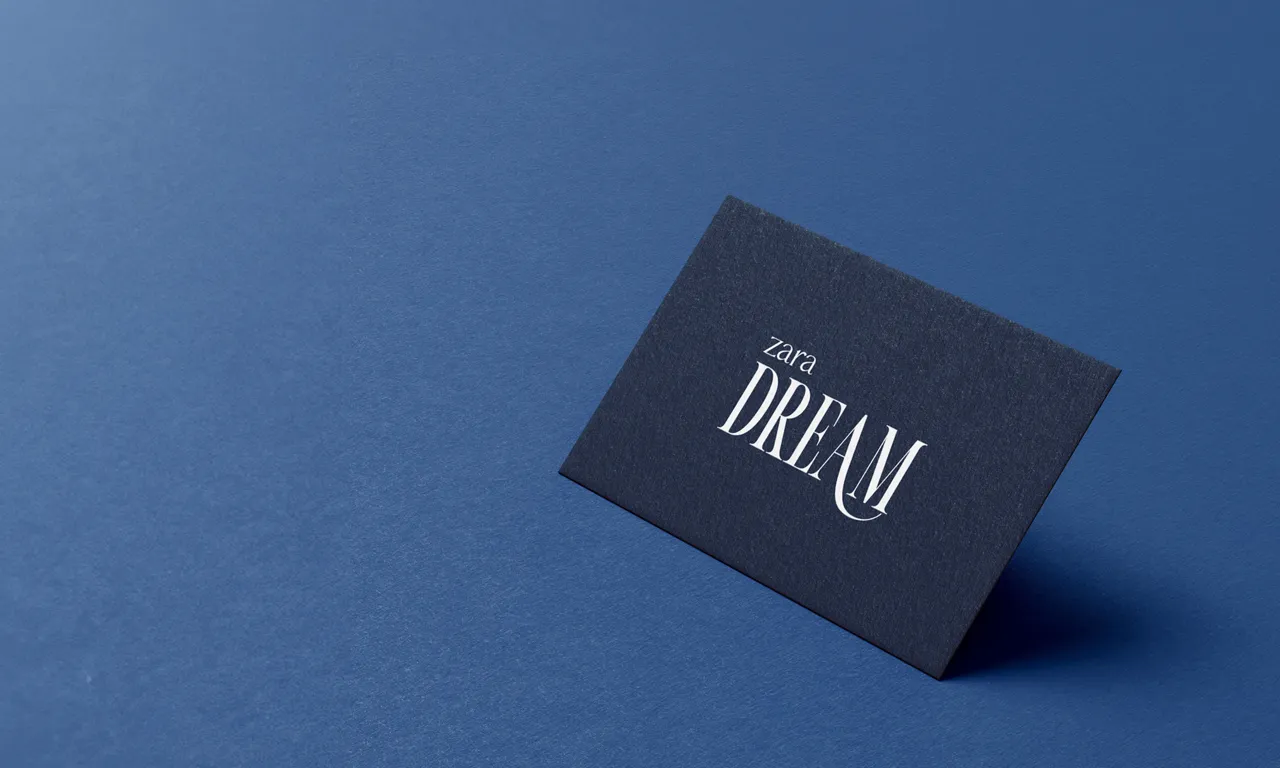 Dark blue card on a blue background with the words 'zara DREAM' in white elegant font.